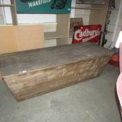 A large old wooden lidded box.