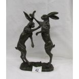 A bronze figure group of 2 boxing hares, approximately 30 cm tall.