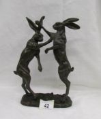 A bronze figure group of 2 boxing hares, approximately 30 cm tall.