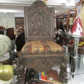 A heavily carved antique Burmese? chair.