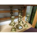 2 pairs and one odd brass candlesticks.