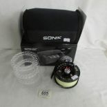 A new Sonik fly reel with 3 spare spools.