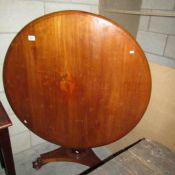 A Victorian mahogany tip top table.