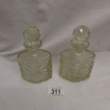 A pair of cut glass scent bottles.