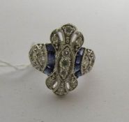 An 18 carat white gold 62 point diamond and square cut sapphire ring, size L.