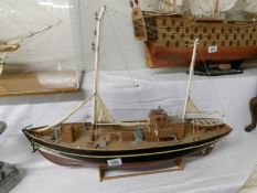 A hand built model of a drifter fishing boat named 'HF 408'.