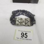 An amethyst bracelet set with an openwork silver clasp.