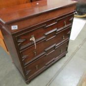 A small mahogany chest of drawers.