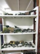 A large quantity of die cast military cannons including Britain's, Lone Star, etc. (3 shelves).