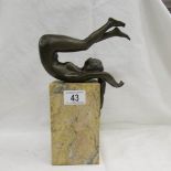 A designer bronze figurine of a naked female on a marble base, approximately 29 cm tall.