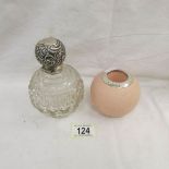 A cut glass scent bottle with silver top (Birmingham 1905/06) and a match striker with silver rim