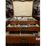 A magnificent silver plate canteen of cutlery in an oak cabinet with 3 drawers.