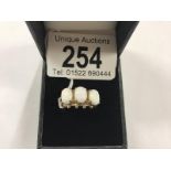 A 9ct gold ring set 3 large opals, size O.