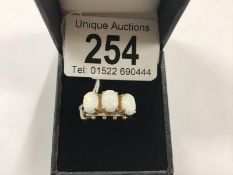 A 9ct gold ring set 3 large opals, size O.