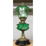 An oil lamp on pot base with green glass font and later green glass shade.