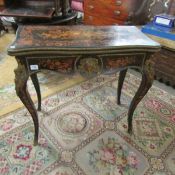 A Victorian marquetry inlaid card table.