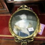 An oval framed portrait of an Edwardian lady with concave glass.