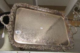 A large ornate silver plate tray with vine leaf and cast grape border.