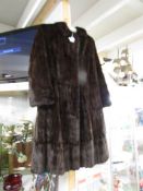 A vintage mink fur coat in a very dark brown / black colour, size 14/16.