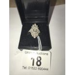An 18 carat white gold and 1 carat diamond ring with centre stone being 20 points, size M.