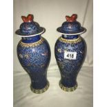 A pair of Chinese lidded vases, in good condition.