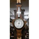 An Edwardian mahogany inlaid barometer with porcelain dial.