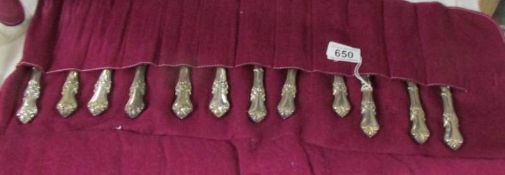 A set of 6 silver handled knives and forks.