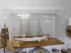 A model of the sailing ship 'The Danmark' in a plastic case.