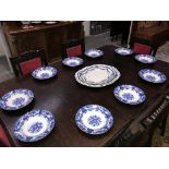 A quantity of blue and white plates and meat platters