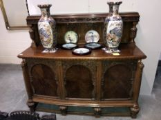 A carved oak 3 door sideboard