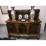 A carved oak 3 door sideboard