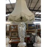 A cut glass table lamp with shade.