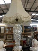 A cut glass table lamp with shade.