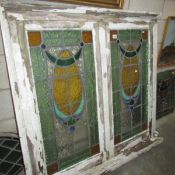 A pair of stained leaded glass windows in a single frame (recovered from a house in Mill Hill,