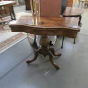 A Victorian walnut fold over card table.