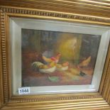 A gilt framed and glazed oil painting depicting chickens signed A Jackson.