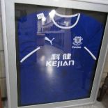 A signed Everton Football Club shirt with approximately 22 signatures including Wayne Rooney,