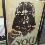 A Star Wars poster featuring Darth Vadar, framed.