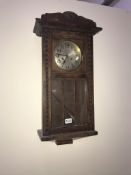 An Edwardian oak wall clock