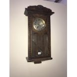 An Edwardian oak wall clock