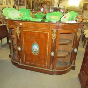 A 19th century ormolu mounted credenza with porcelain panels.