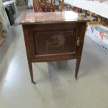 An Edwardian mahogany inlaid washstand with inset marble top.