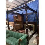 A carved dark wood 4 poster bed frame