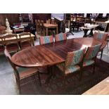 A large oval extending dining table with 2 leaves and 6 upholstered chairs