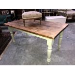 A pine top table with painted legs