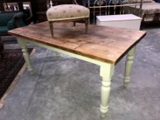 A pine top table with painted legs