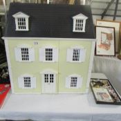 A dolls house full of good quality furniture.
