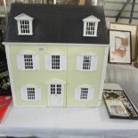 A dolls house full of good quality furniture.