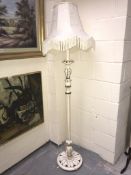 A white painted standard lamp