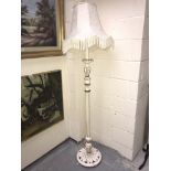 A white painted standard lamp